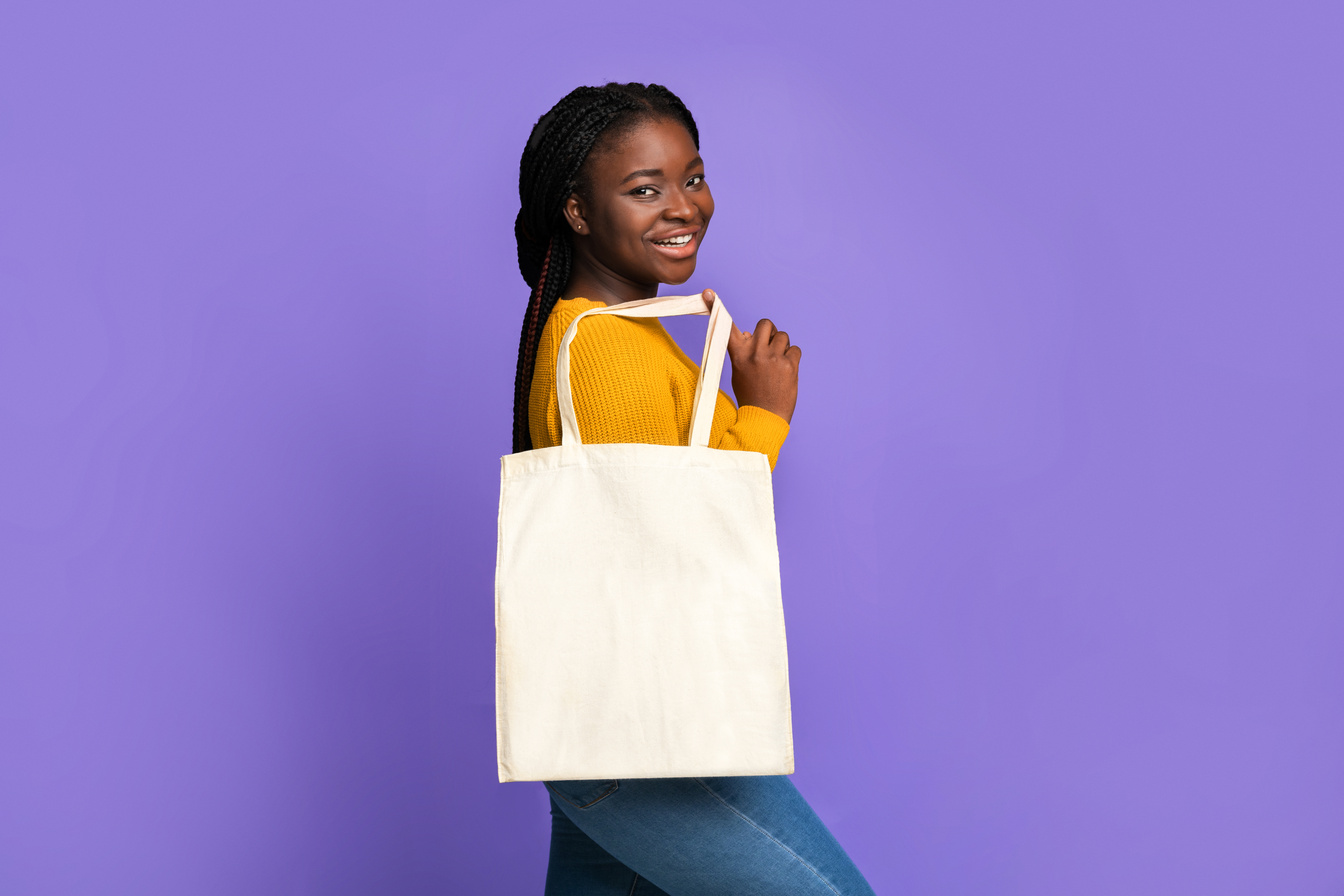 Joyful African Female Posing With Blank Tote Bag With Mockup For Design
